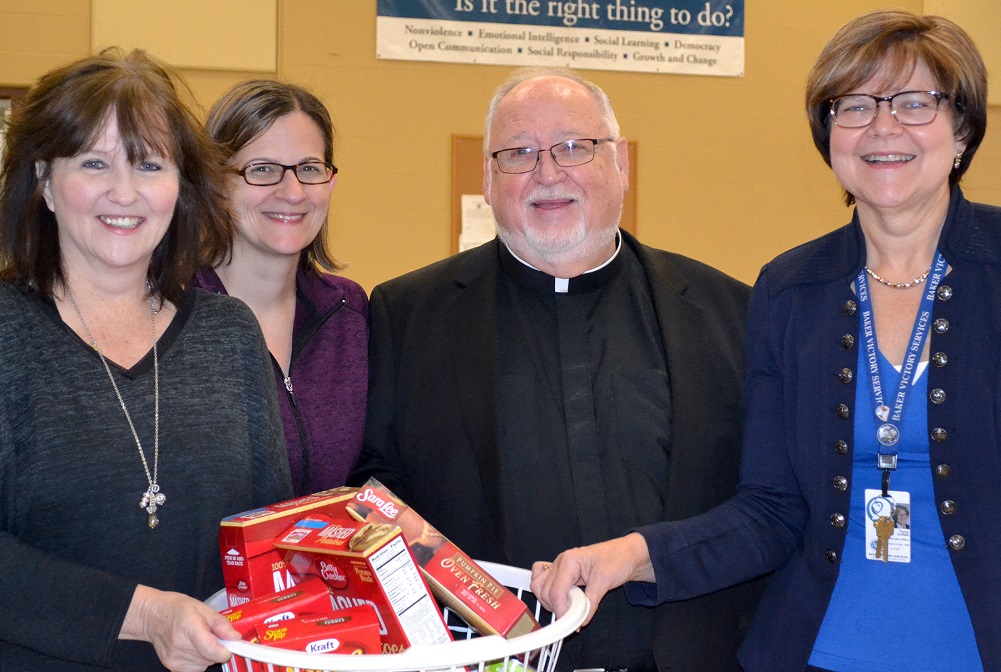 Thanksgiving basket committee co-chairs Nancy Doyle and Leslie Haick were joined by Msgr. Paul Burkard and BVS CEO Terese Scofidio in packing and preparing more than 120 Thanksgiving baskets for needy families. 